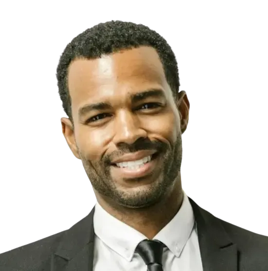 Headshot of smiling man in suit and tie on plain background